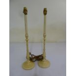 A pair of painted wooden candlesticks converted to electric lamps