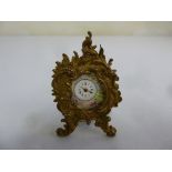 A miniature Viennese enamel clock in a Rococo gilt metal easel frame