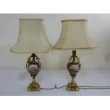 A pair of Sevres style blue ground table lamps on raised square bases with silk shades