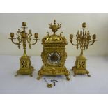 French 19th century brass clock set scroll pierced case surmounted by an urn the white enamel dial