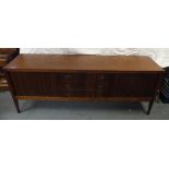 1970s rectangular teak sideboard with sliding doors, three drawers on four tapering rectangular