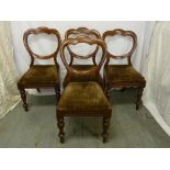 Four Victorian mahogany balloon back dining chairs on turned cylindrical legs