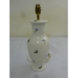 A baluster form porcelain lamp stand decorated with butterflies