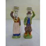 A pair of Quimper candlesticks in the form of peasants