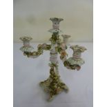 A Continental porcelain four light candelabrum decorated with flowers and leaves