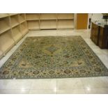 A Persian wool carpet, light blue ground with repeating medallions, swags and flowers, 422 x 319cm