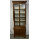 A rectangular mahogany display cabinet with glazed top section above two drawers and cupboard