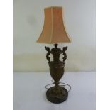 A bronze table lamp in the form of a vase on marble base with silk shade