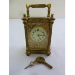 A brass carriage clock of customary form enamel dial, Arabic numerals, to include key, A/F