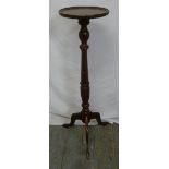 A mahogany plant stand on tripod base with outswept legs
