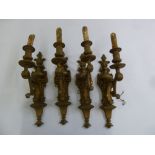 A set of four gilt metal wall lights in classical style