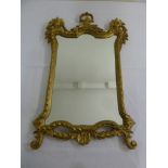 A gilded rectangular wall mirror carved with leaves and scrolls in the French 19th century style