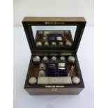 A Victorian walnut travel boudoir set with silver covers to glass containers and mother of pearl