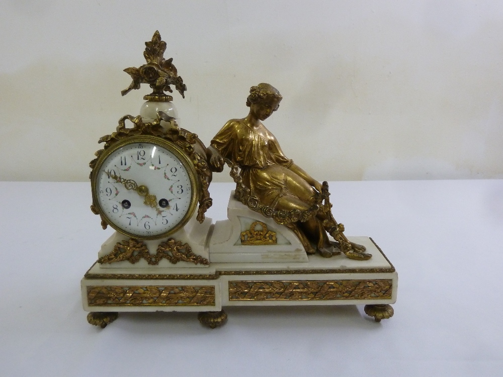 A French 19th century gilt metal and white marble mantle clock, the circular enamel dial flanked