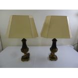 A pair of cast gilt metal lamp bases with silk shades