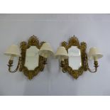 A pair of brass and mirrored hall wall two branch lights