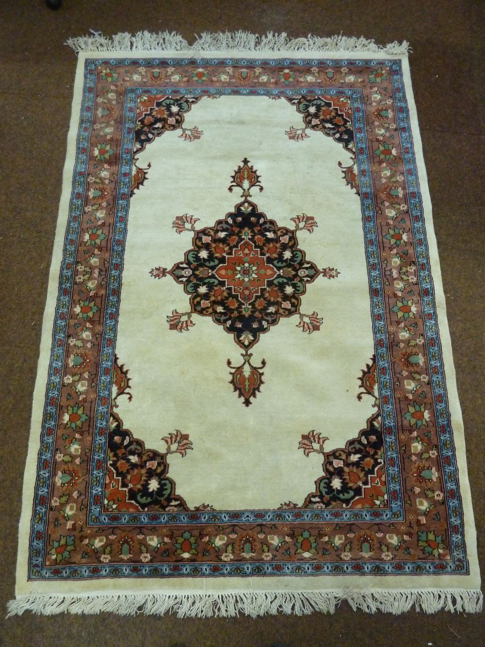 A Kashmir hand knotted rug with central medallion within geometric borders, 194.5 x 133cm