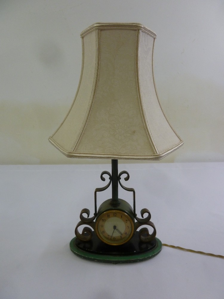 A table lamp clock with scroll mounts and silk shade