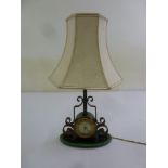 A table lamp clock with scroll mounts and silk shade