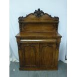 A Victorian mahogany chiffonier, rectangular with two hinged cupboard doors on rectangular plinth