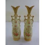 A pair of blush ivory porcelain vases, decorated with flowers and pierced scroll handles, 30cm (h)