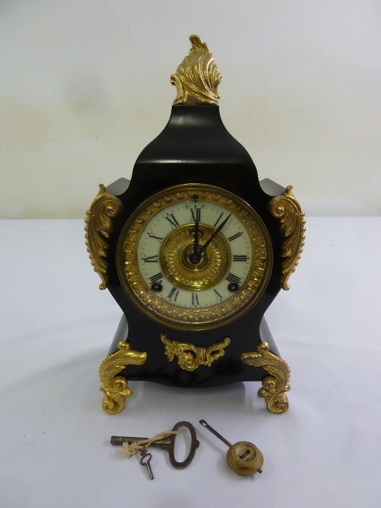 A black slate with gilded mounts mantle clock, enamel dial, Roman numerals, two train movement to