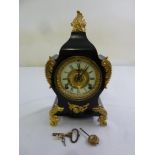 A black slate with gilded mounts mantle clock, enamel dial, Roman numerals, two train movement to