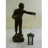 A brass lamp stand in the form of a miner holding a lamp, A/F