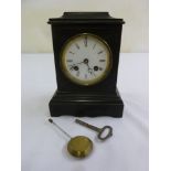 A black slate mantle clock enamel dial, Roman numerals, two train movement to include key and
