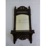 A mahogany framed wall mirror in Gothic style