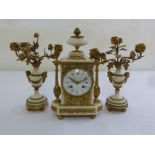 A French Le Roy 19th century ormolu and white marble mantle clock, flanked by vase form garnitures
