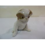 Royal Copenhagen figurine of a seated dog, designed by Erik Nielsen, marks to the base, 14cm (h)