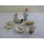 A quantity of porcelain to include two figurines and miniature cabinet cups and saucers (8)