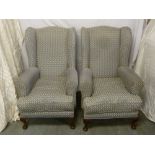 A pair of Edwardian high back armchairs on cabriole legs