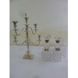 A pair of cut glass decanters with silver collars, two silver wine labels, a silver plated five