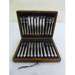 A cased set of silver handled dessert eaters, twelve place setting