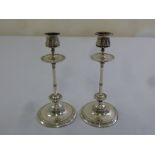 A pair of Swedish silver table candlesticks, cylindrical stems and circular spreading bases
