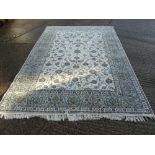 A Persian wool carpet blue ground, cream and blue borders with repeating floral pattern, 324 x