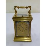 A Victorian repeating carriage clock of architectural form on stepped square base with swing handle