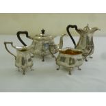 A silver four piece tea set, rounded oval form with scroll handles and scroll feet, Birmingham 1907