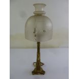 An Art Nouveau brass table lamp with etched glass shade on tri-form base