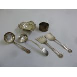 A quantity of silver to include a bonbon dish, a napkin ring, two silver sifter spoons and a pair of