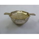 A silver tea strainer on stand octagonal form, Birmingham 1920