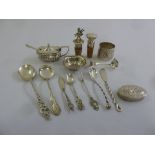 A quantity of silver and white metal to include a mustard pot and spoon, a napkin ring, two bottle