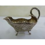 Dutch silver sauce boat, oval chased with flowers and leaves on four scroll feet, import mark