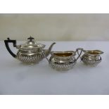 A late Victorian silver three piece bachelor teaset rounded rectangular, part fluted, Sheffield