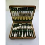 A cased set of silver plated flatware six place setting to include dessert and table knives