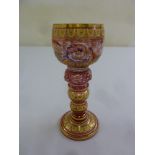 An early 19th century Bohemian pink goblet decorated with gilt and enamel flowers leaves and