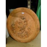 Circular moulded terracotta plaque with figure and cherubs decoration.