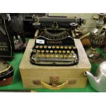 An early Corona portable typewriter with case.